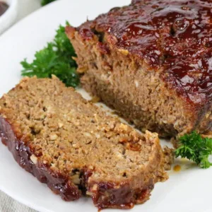 Simple BBQ Meatloaf sliced on white plate