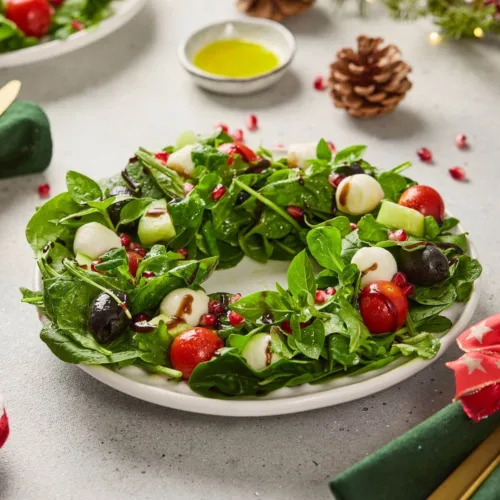 Christmas salad shaped like a wreath on a white plate