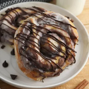 brownie cinnamon rolls being served on a white plate