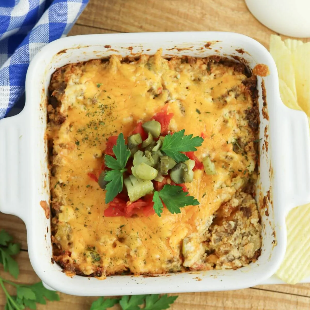 Warm baked cheeseburger dip in a white serving dish.