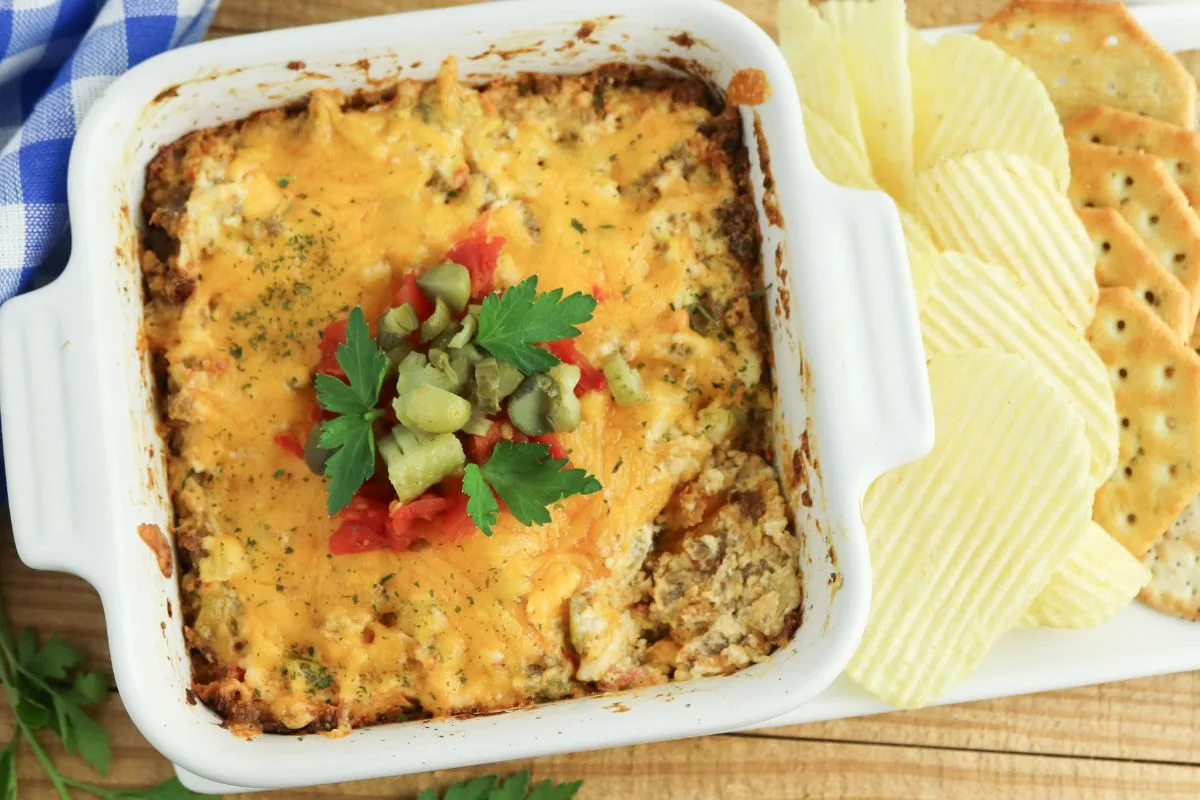 rotel cheeseburger dip served on a white plate with chips and crackers