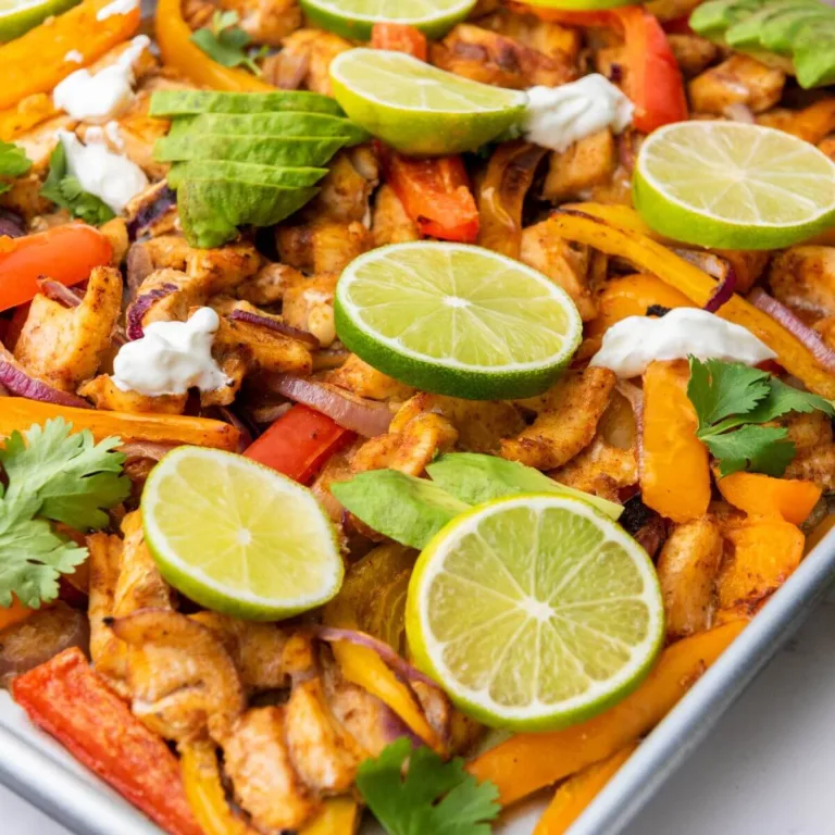 Close up view of sheet pan chicken fajitas on baking sheet.