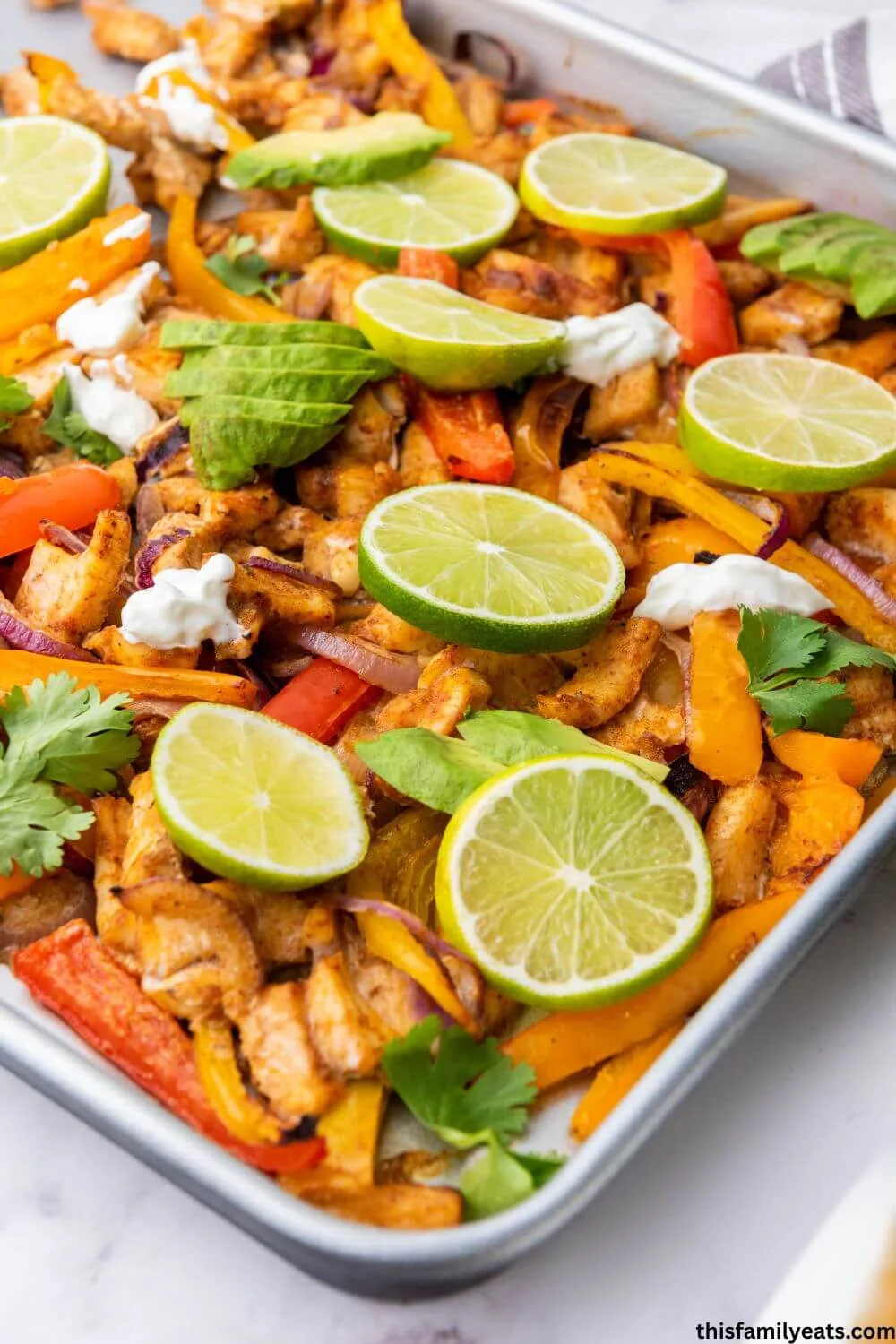 Cooked chicken fajita mixture on a metal sheet pan.