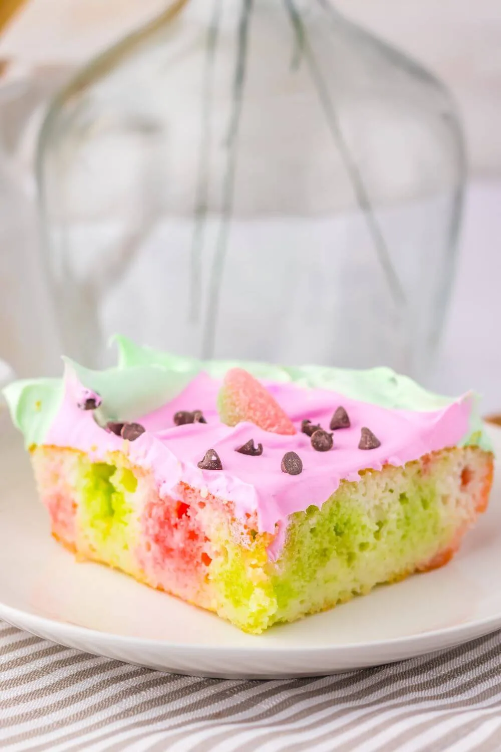 Slice of poke cake with watermelon flavored jello.