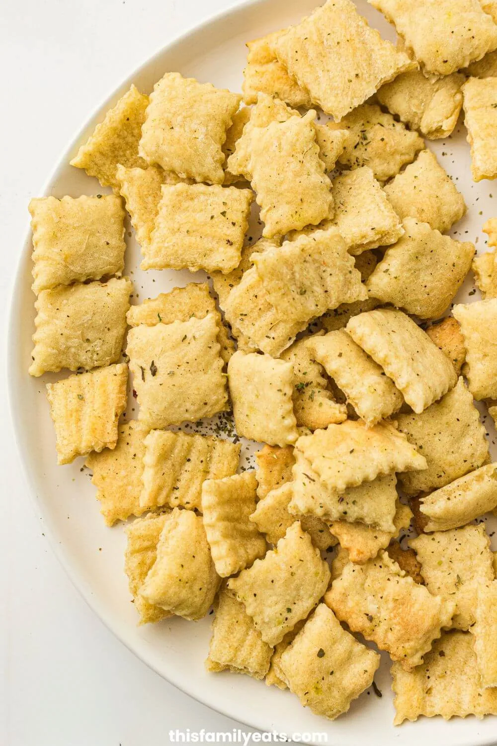 Sourdough crackers spread out on a plate.