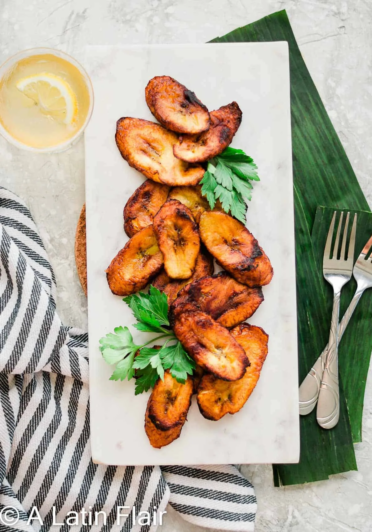 Sweet Fried Plantains on white dish and plantain leaf MAIN