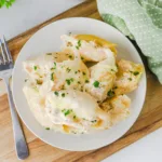 Plate of chicken stuffed shells with alfredo sauce.