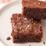 Sheet pan brownies cut into squares and served on a plate.