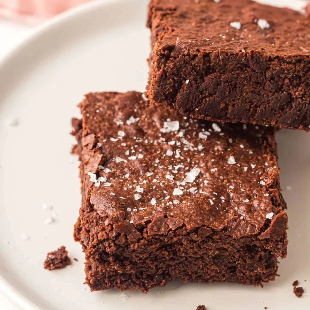 Sheet pan brownies cut into squares and served on a plate.